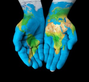 Map painted on hands showing concept - the world in our hands